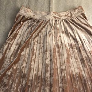 Midi-length pink velvet skirt.